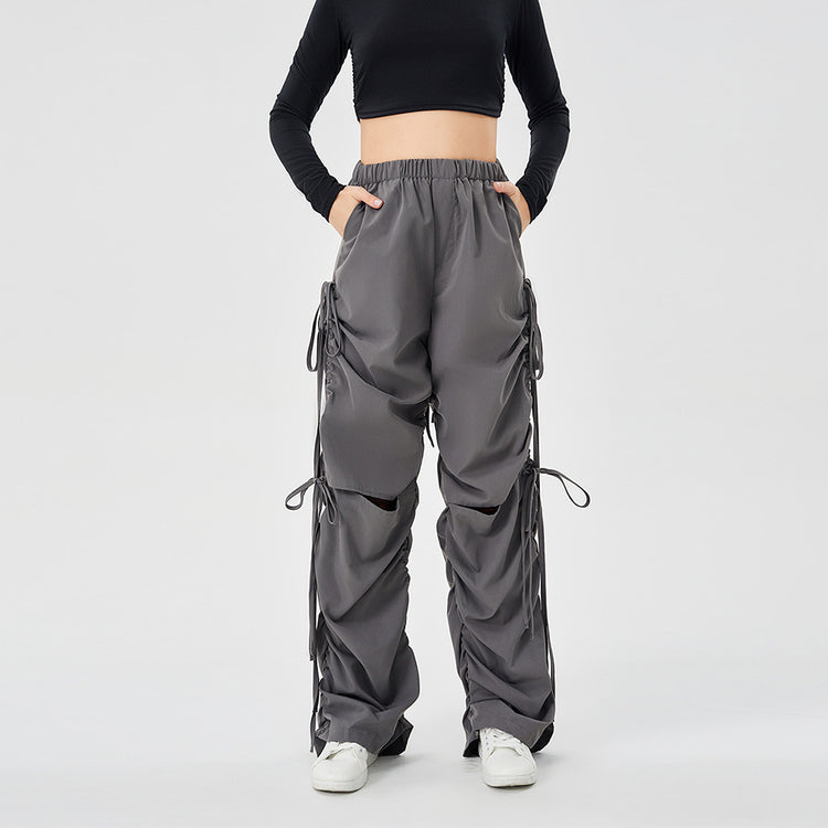 a person wearing a black top and grey pants