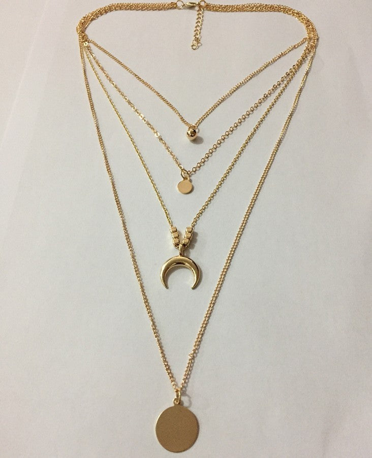 a gold necklace with pendants