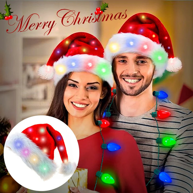 a man and woman wearing santa hats and lights