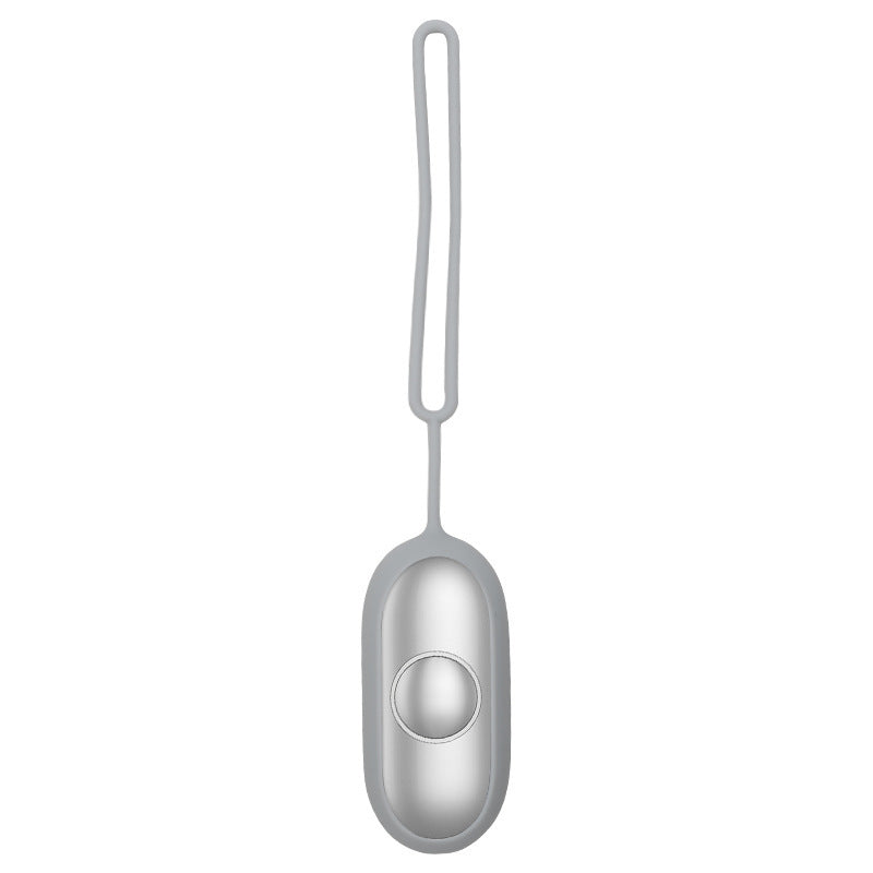 a silver object with a round button