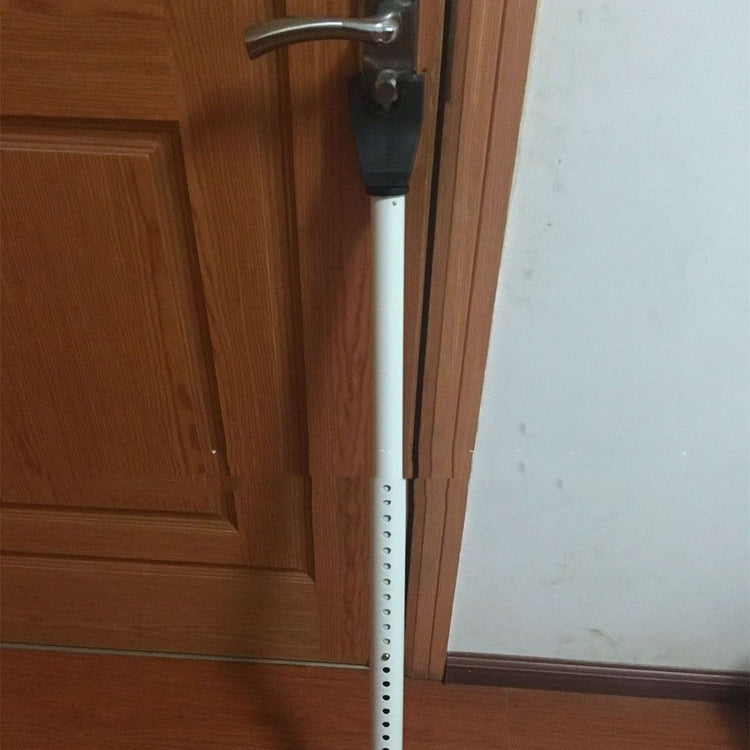 a white pole with a handle on a door