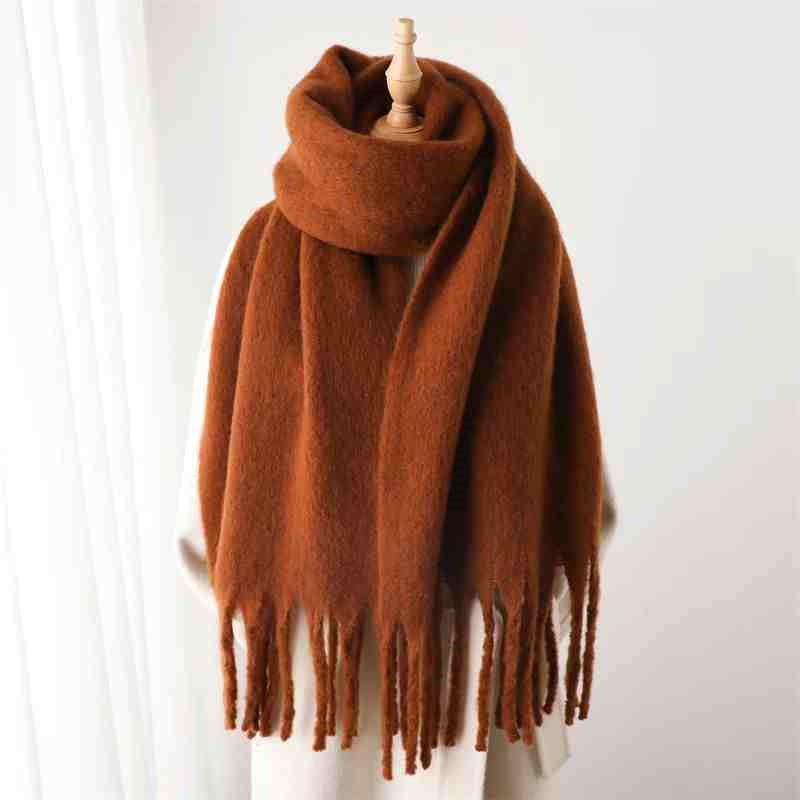 a brown scarf on a mannequin
