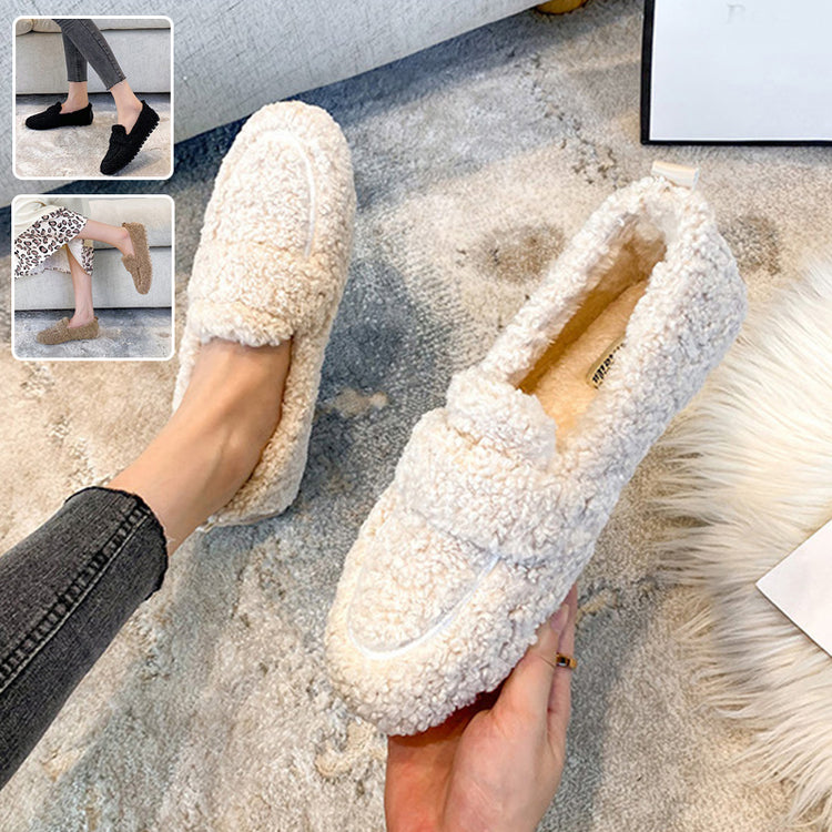 a person holding a pair of slippers