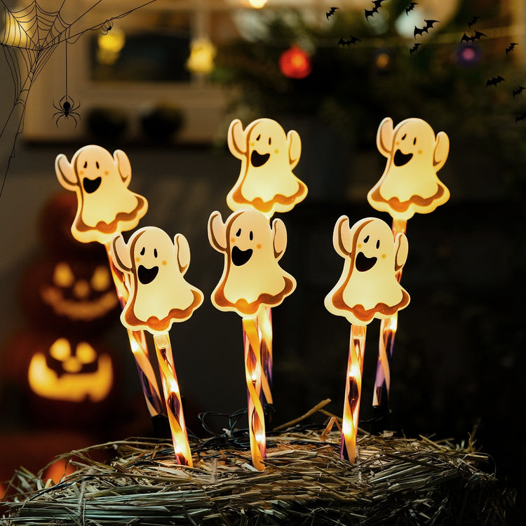 a group of candles with ghosts on them