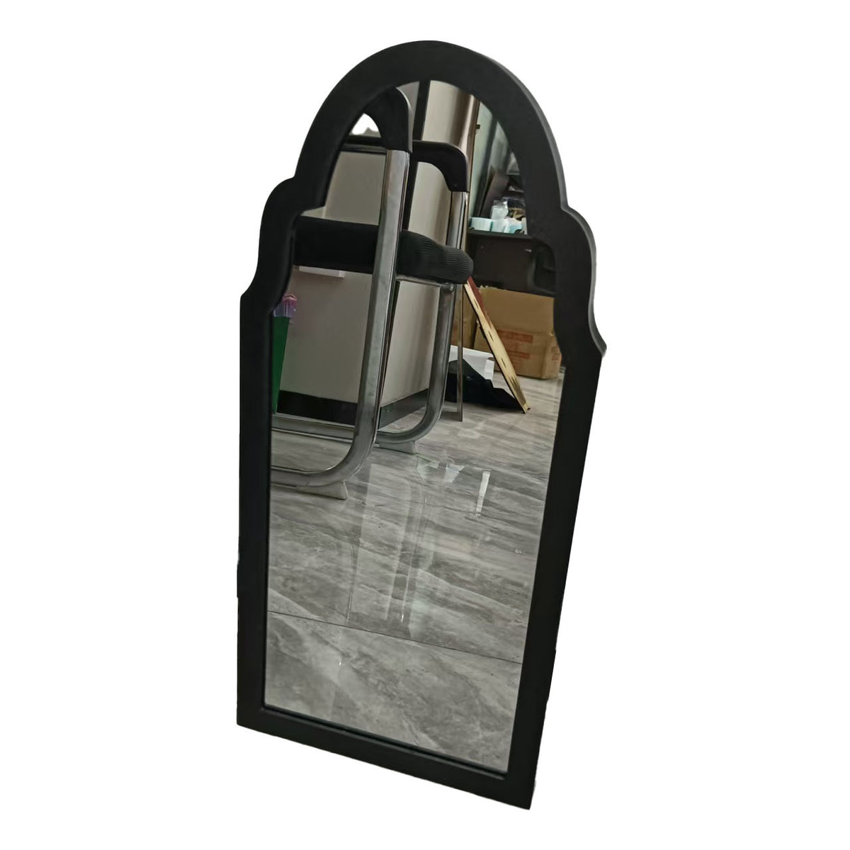 a mirror with a chair in the background