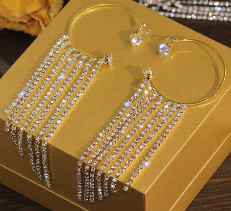 a pair of earrings on a box