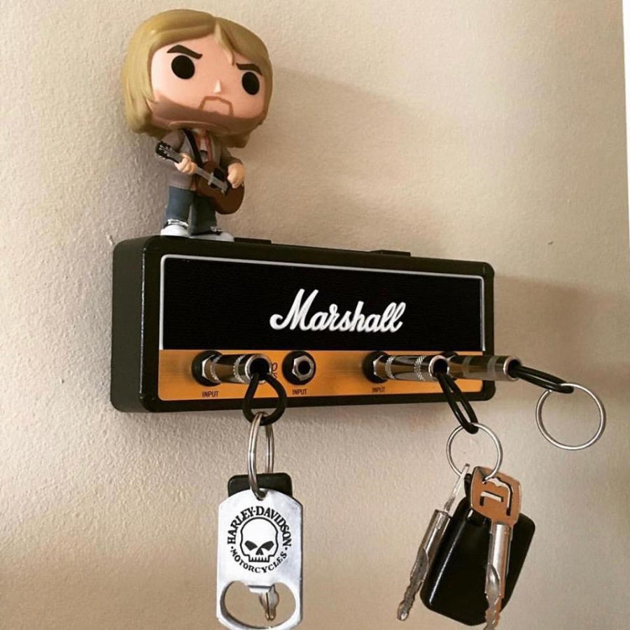 a toy figurine on a speaker
