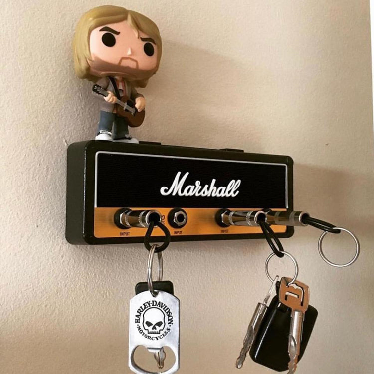 a toy figurine on a speaker