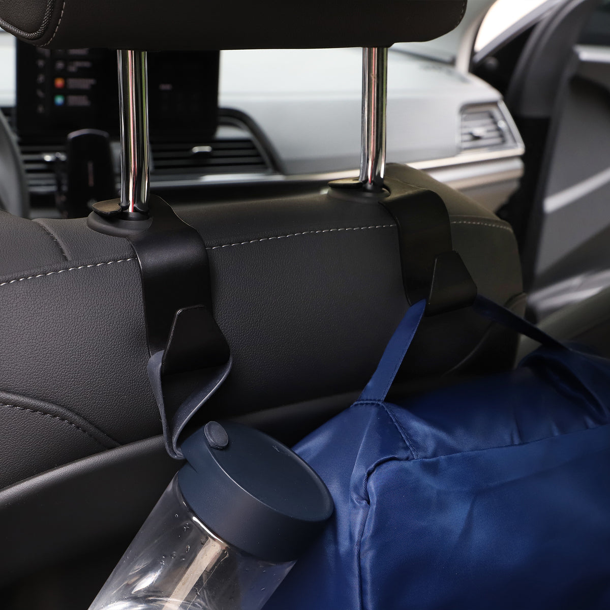 a bag and a bottle on the back of a car