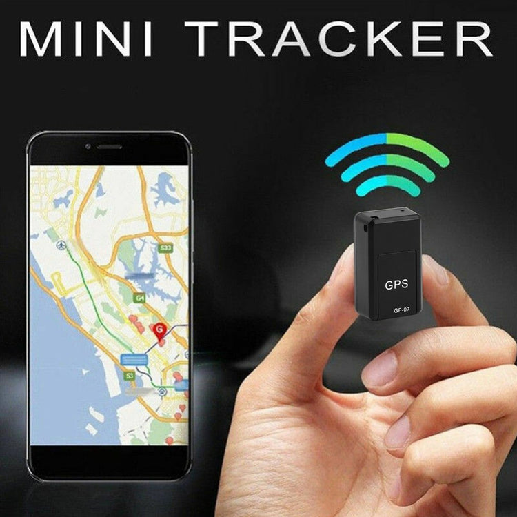 a hand holding a small gps device