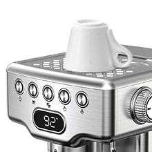a coffee maker with a white cup on top