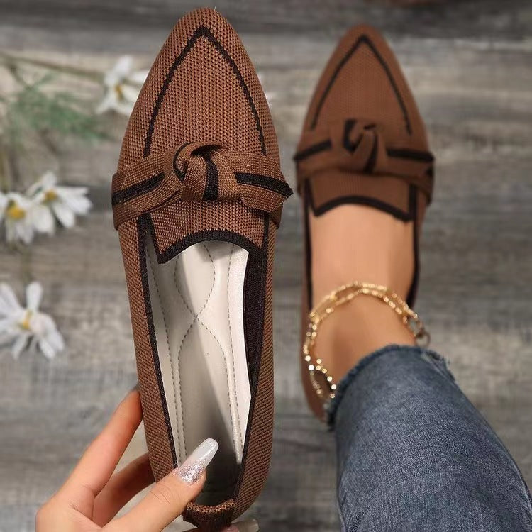 a person holding a brown loafer