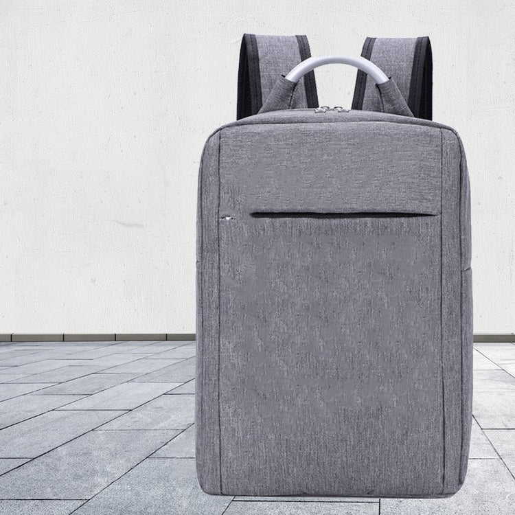 a grey backpack on a tile floor