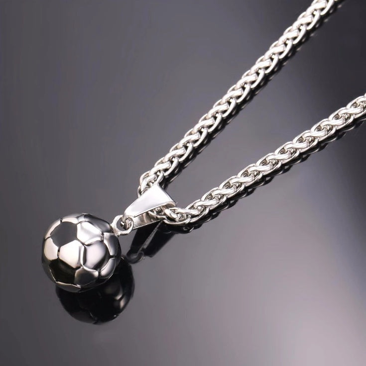 a silver chain with a football ball pendant