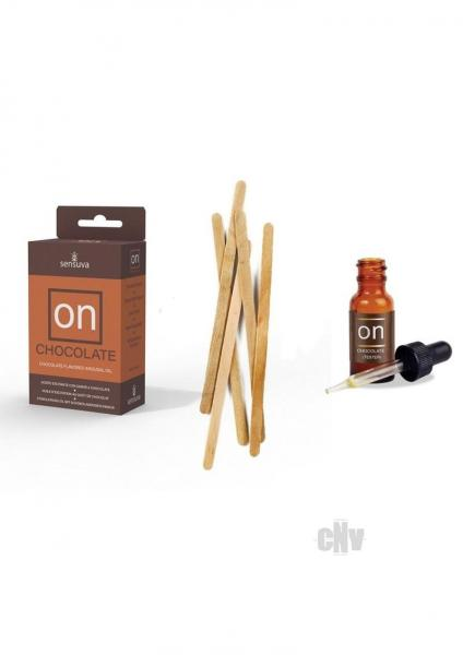 a brown bottle and brown container with brown liquid next to a brown container with brown liquid and wooden sticks
