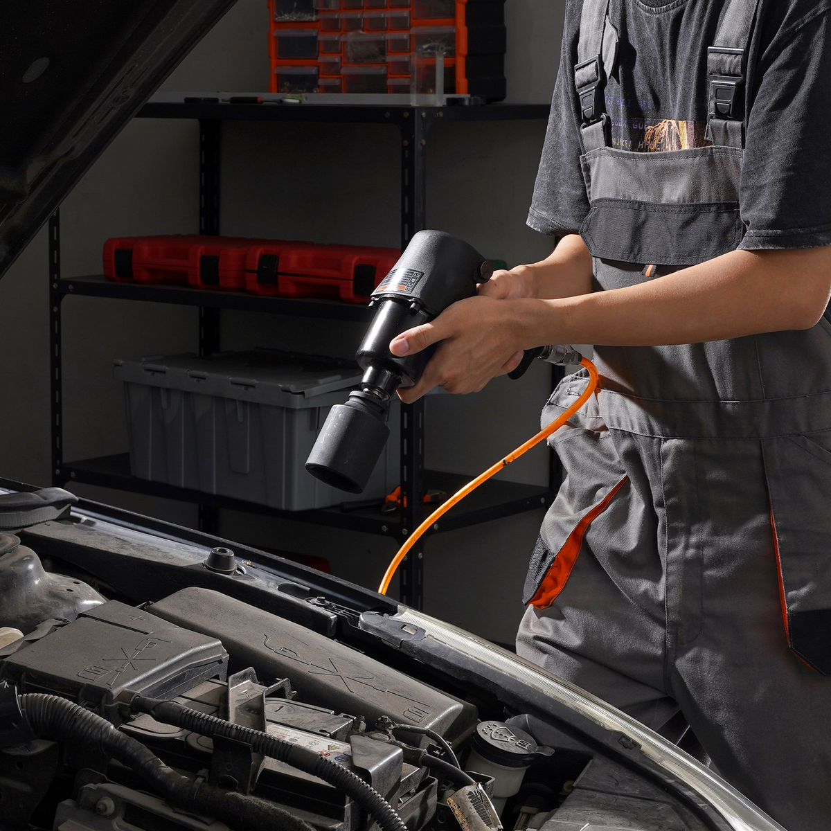 a man holding a drill in a garage