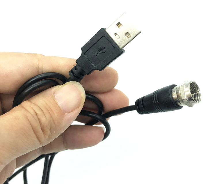 a hand holding a black cable