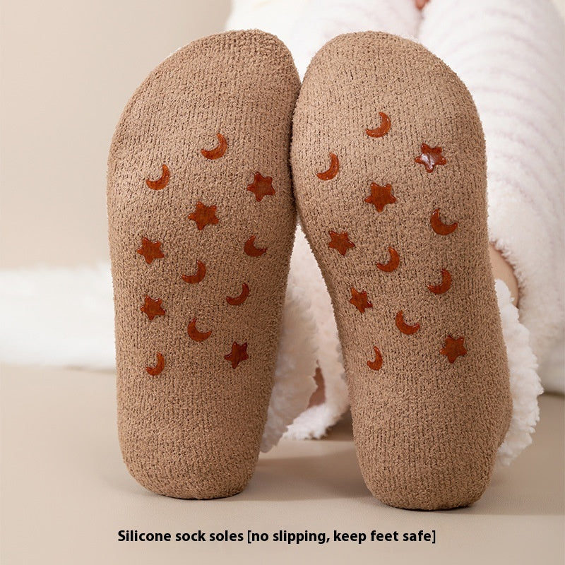 a pair of brown socks with stars and moon on them