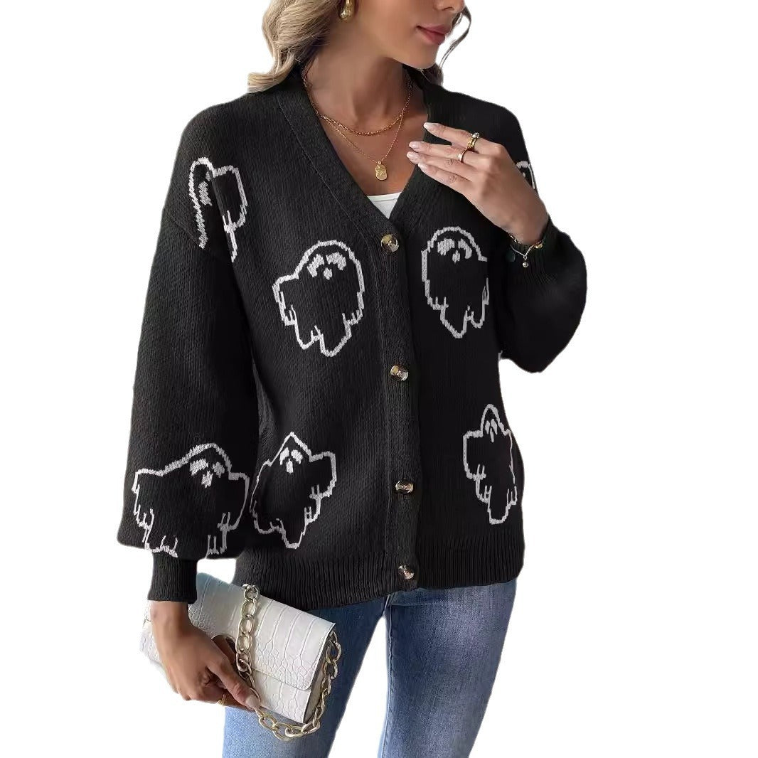 a woman wearing a black cardigan with white ghosts on it