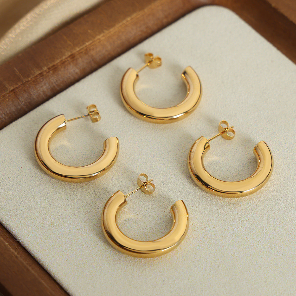 a group of gold hoop earrings
