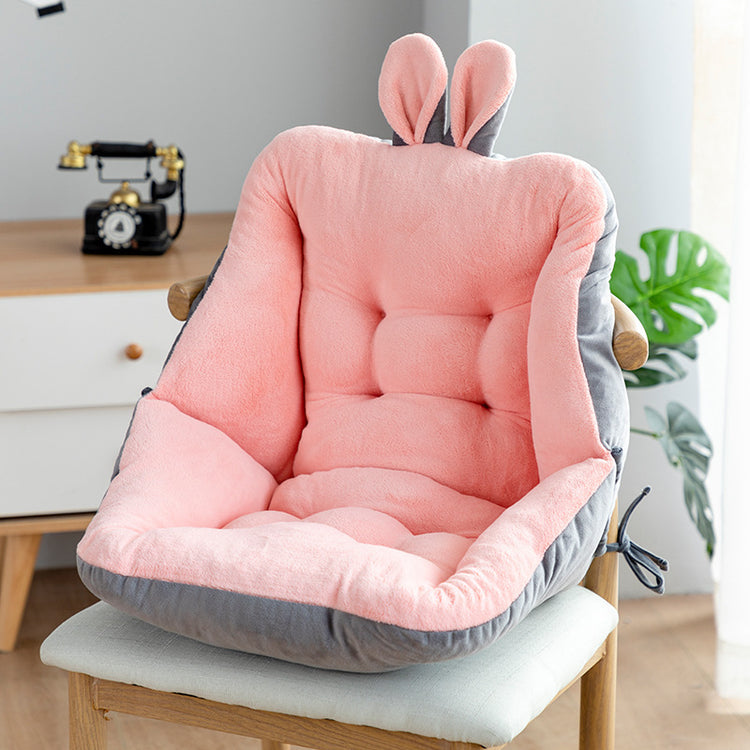 a pink and grey chair with a bunny ears pillow