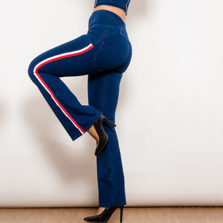 a woman wearing blue jeans and high heels