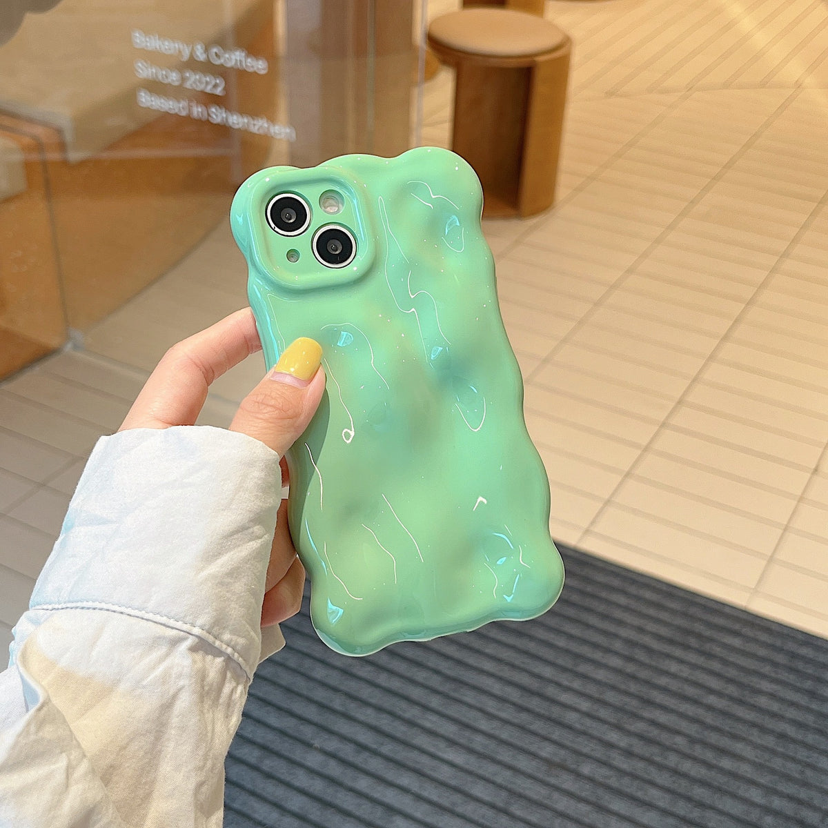 a hand holding a phone case