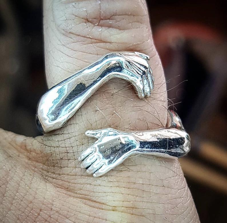a silver ring on a person's finger