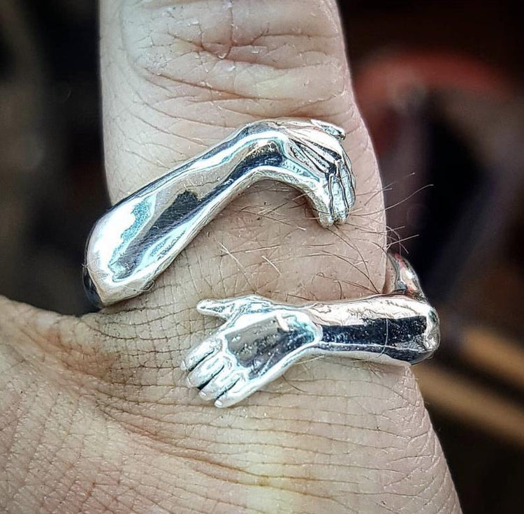 a silver ring on a person's finger