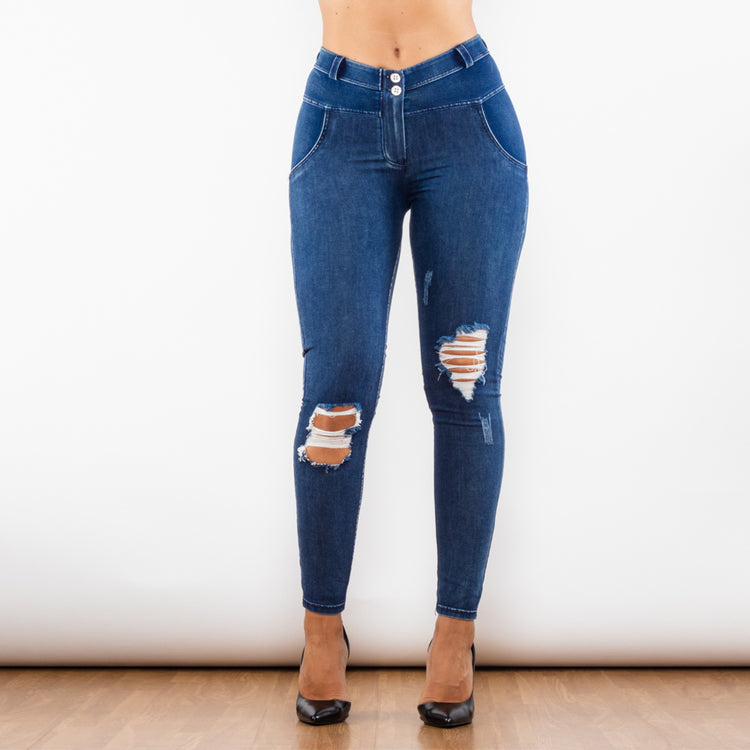 a woman wearing ripped jeans