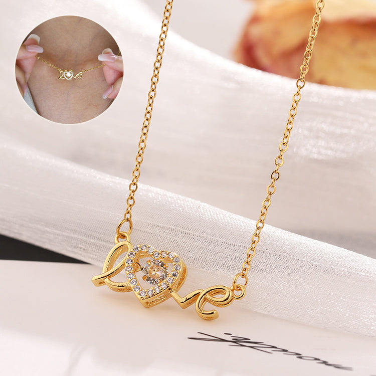 a gold necklace with a heart pendant