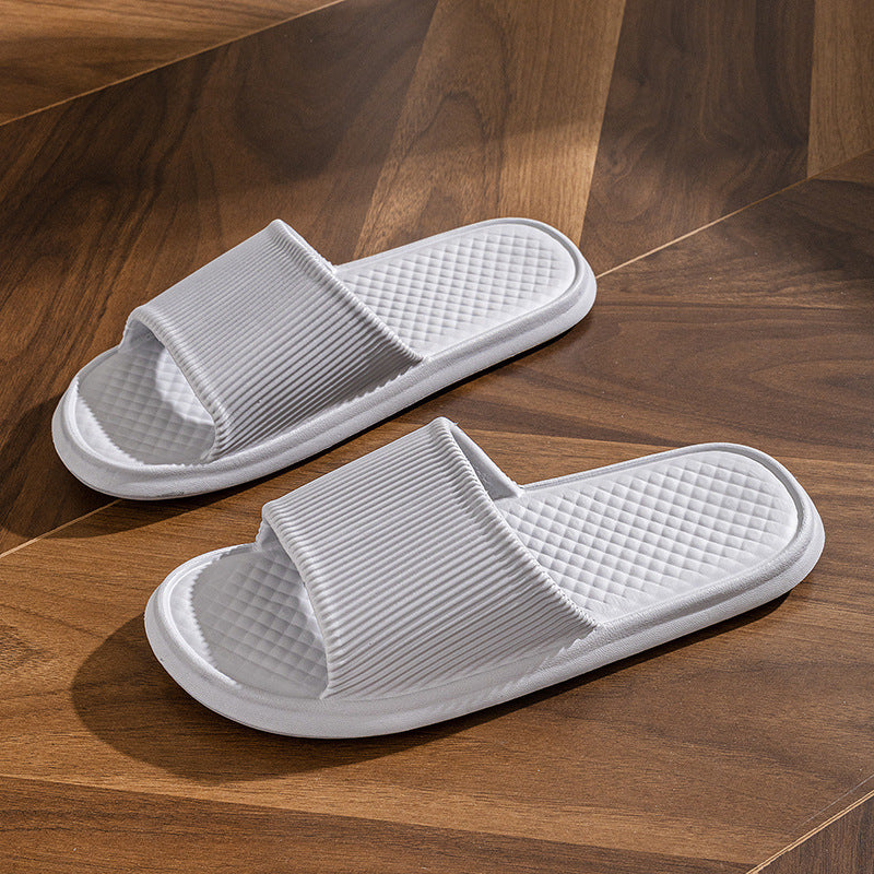 a pair of white slippers on a wood floor