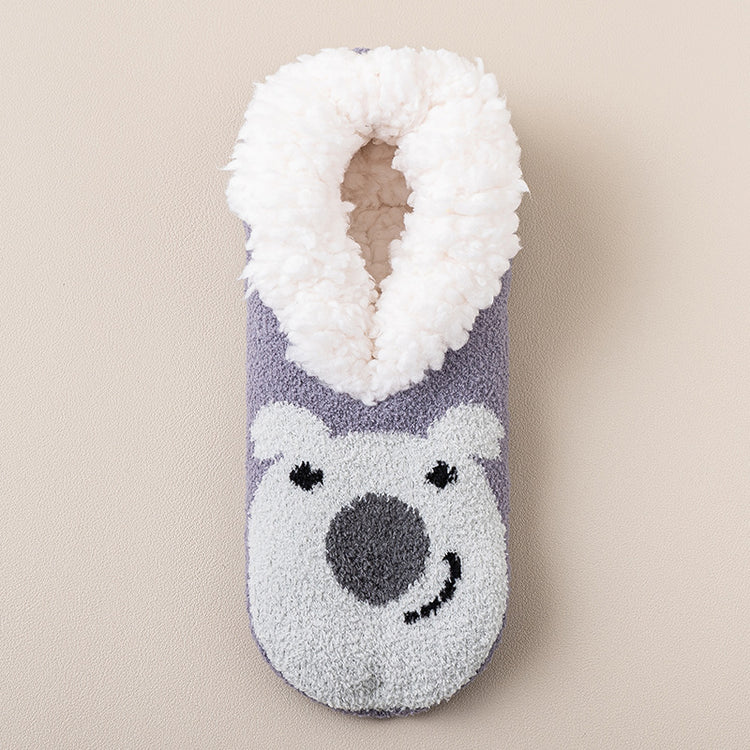 a fuzzy slipper with a bear design