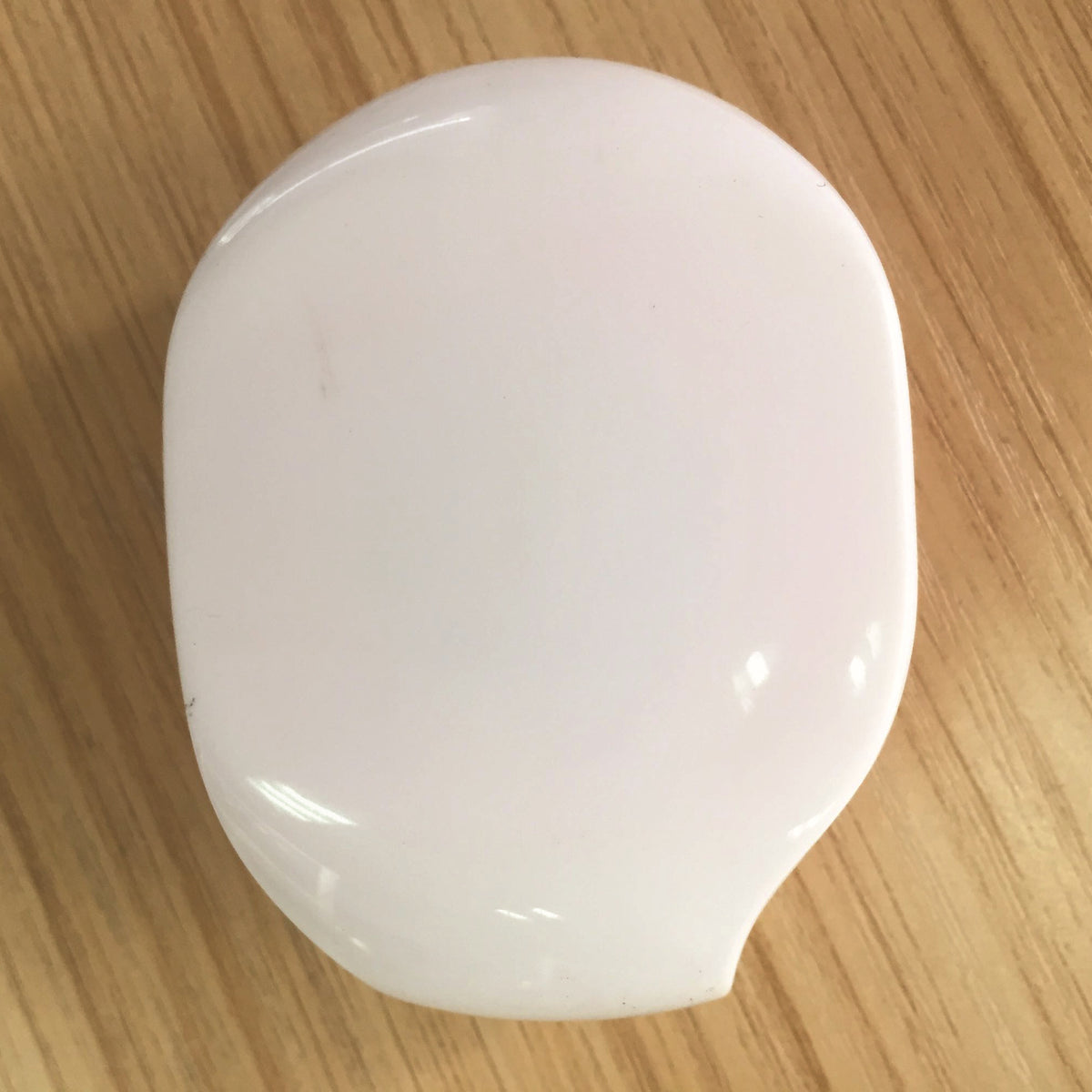 a white object on a wood surface