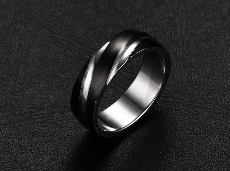 a silver ring on a black surface