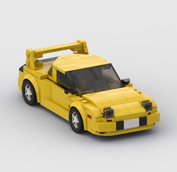 a yellow toy car with a wing