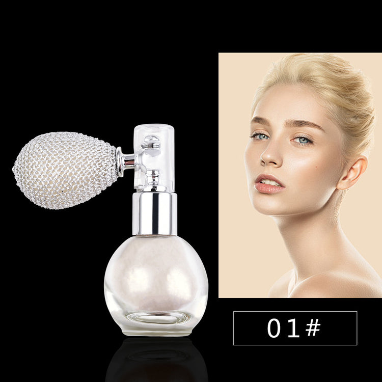 a bottle of perfume with a silver object