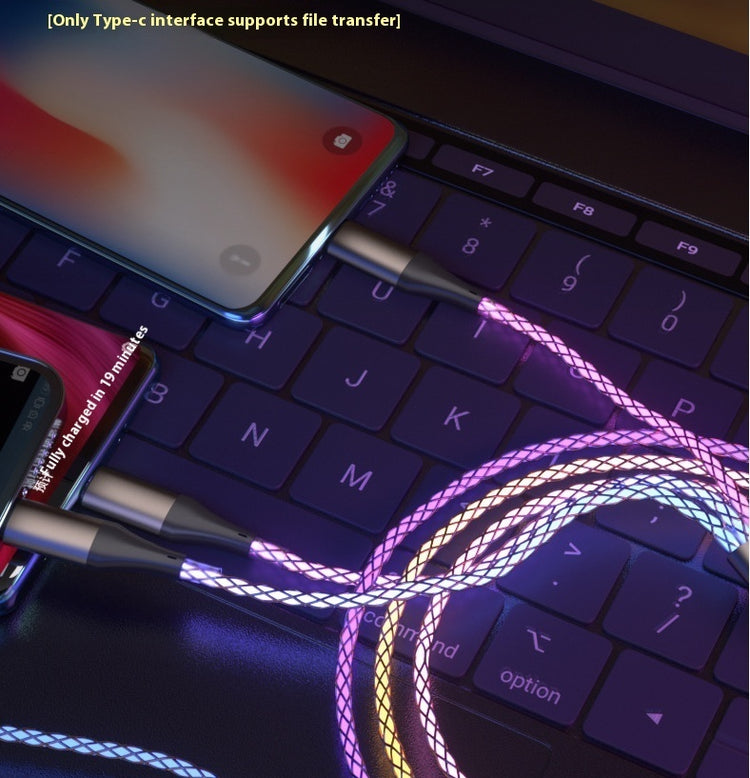 a phone and a charger on a laptop