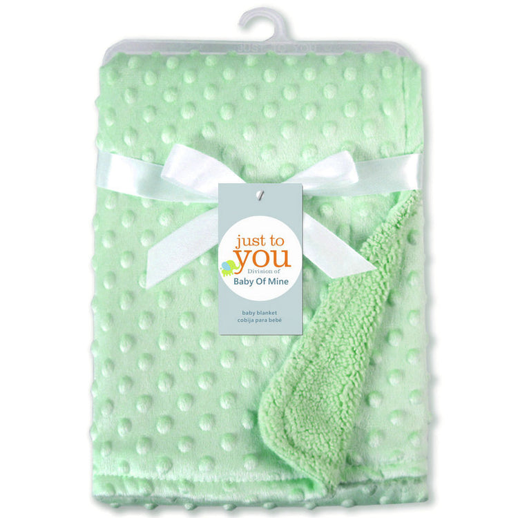 a green blanket with a white bow