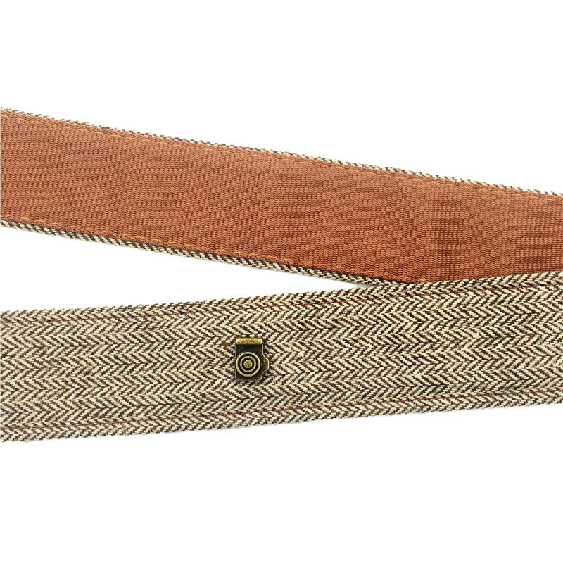 a brown belt with a small button