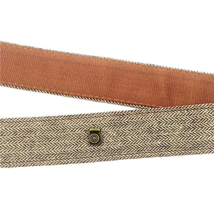 a brown belt with a small button