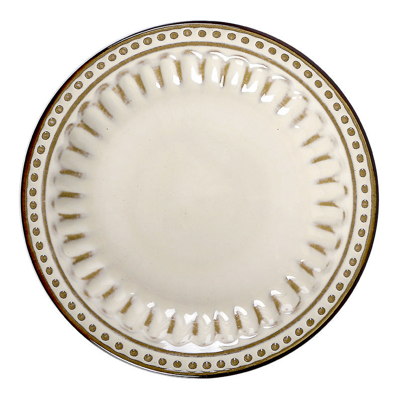 a white plate with gold trim