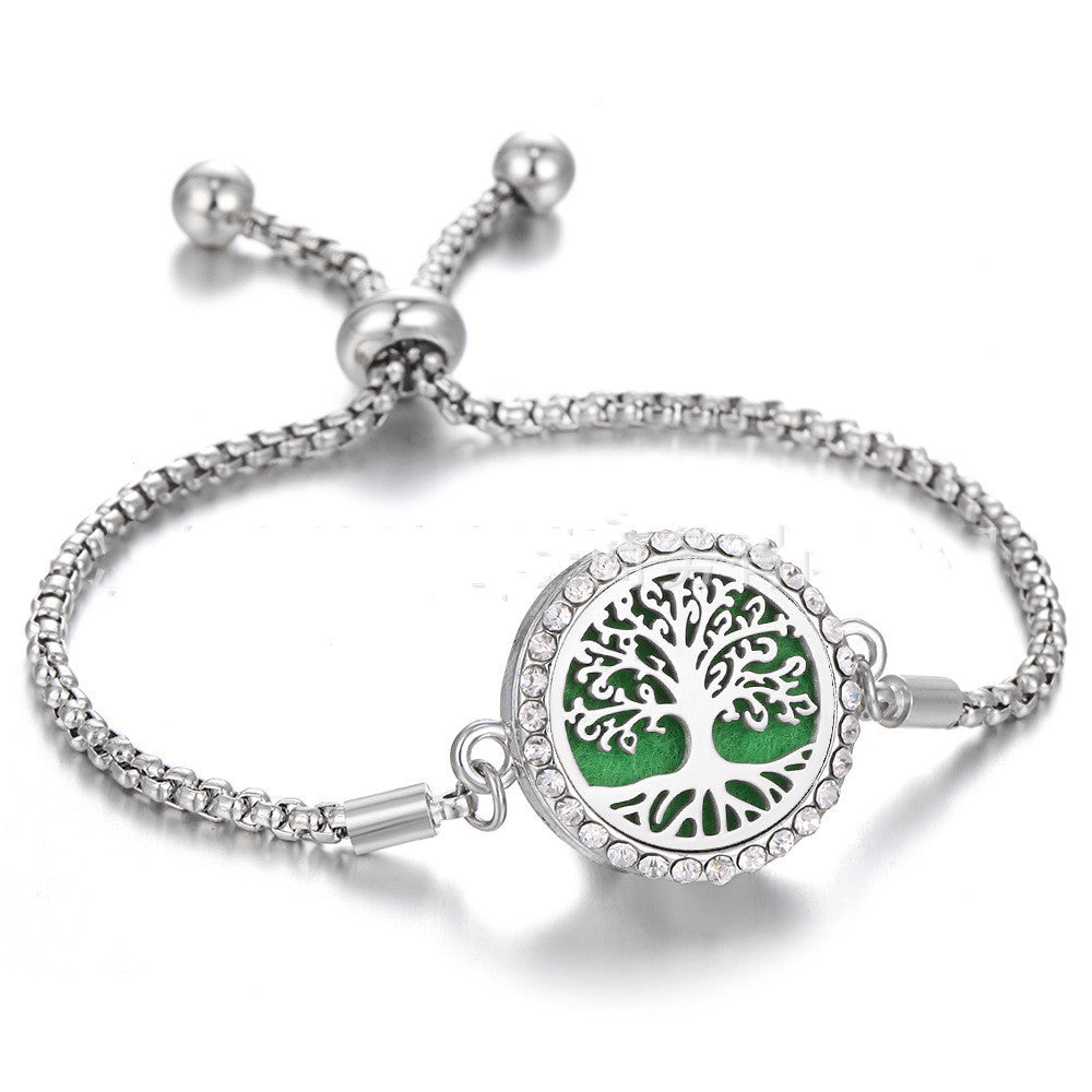 a silver bracelet with a green circle with a silver chain
