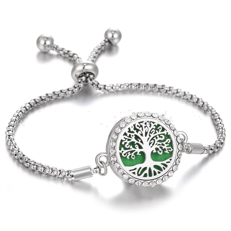 a silver bracelet with a green circle with a silver chain