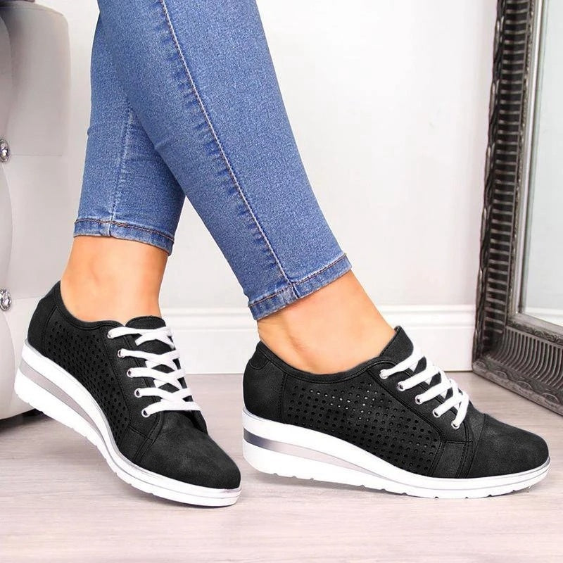 a pair of legs wearing black sneakers