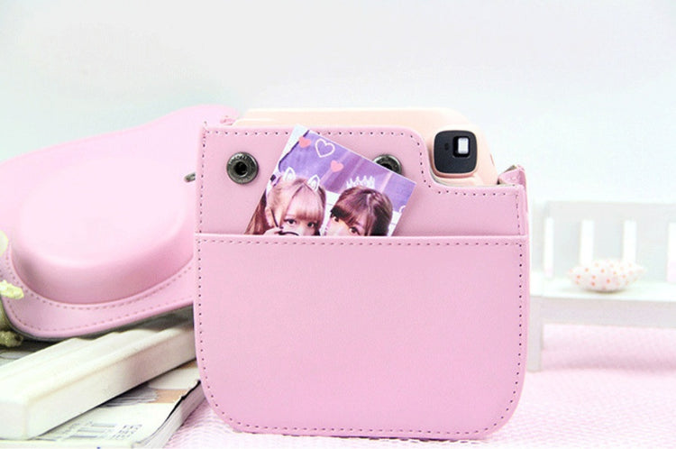a pink camera case with a picture of girls in it