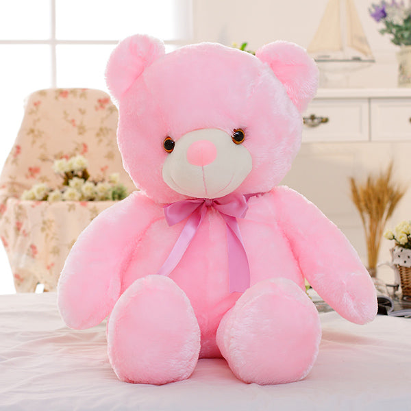 a pink teddy bear on a table