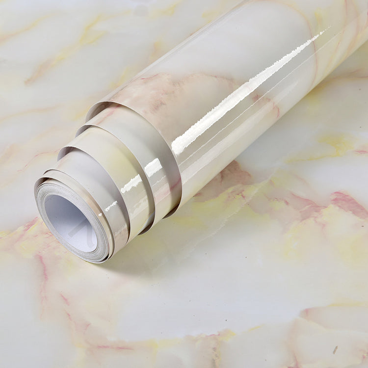a roll of white and pink wallpaper