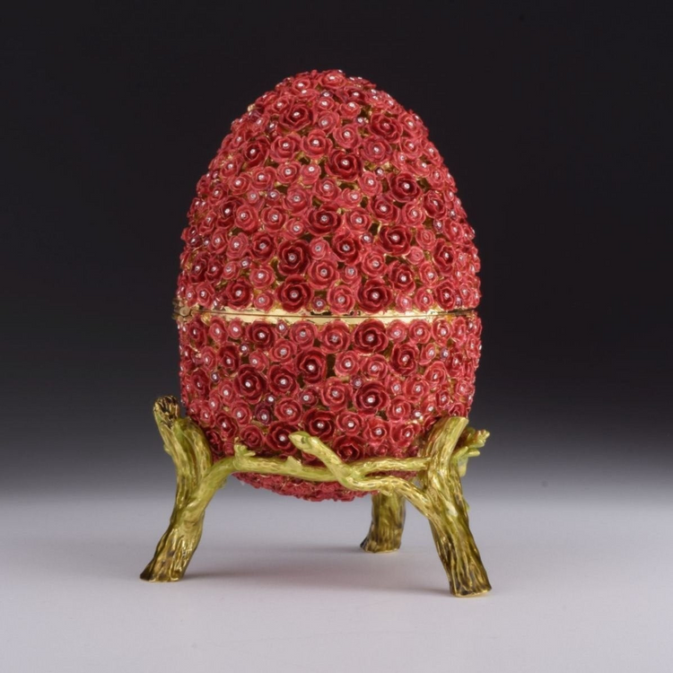 a red egg shaped object with flowers on it