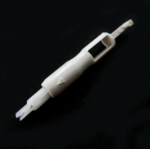 a white plastic object with a hole